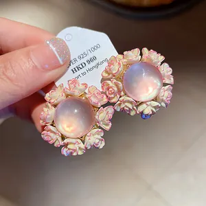Macro detail view of elegant round floral resin stud earrings with silver needles