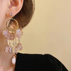 Elegant pink petal dangle earrings with zirconia stud worn by a professional model