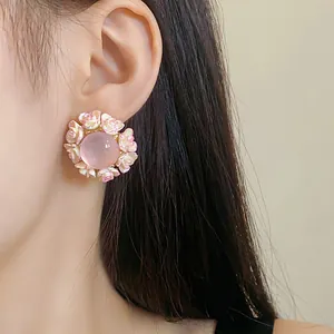 Detailed close-up showing a pink floral resin stud earring worn on an ear for a sweet style