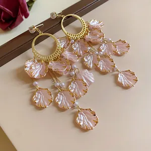 Elegant pink petal dangle earrings with gold finish and zirconia details for women.