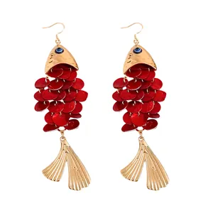 Red koi fish dangle earrings with gold tassels and evil eye detail for beach holidays