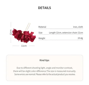 Detail showing size and material of a red fabric flower hair fork on white background