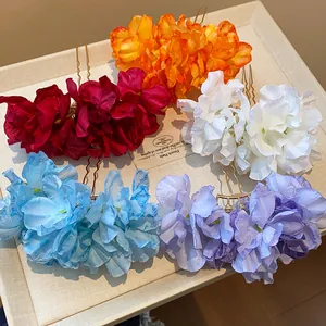 Detailed view of colorful fabric flower hair pins in red, white, blue and purple