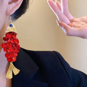 Detailed close-up view of elegant red sequin koi fish tassel earrings for vacation