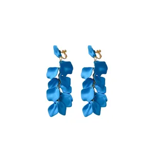 Vibrant blue ruffled petal tassel ear clips with gold-tone hardware on white