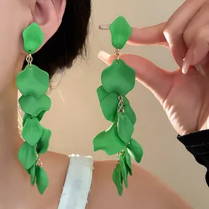 Detailed close-up view of vibrant green ruffled petal tassel long drop earrings
