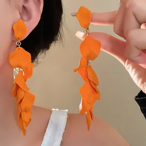 Dramatic orange flower petal tassel clip-on earrings for a bold and trendy fashion statement.