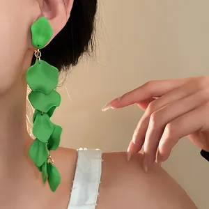Close-up of elegant green matte petal tassel clip-on earrings worn on a female model's ear