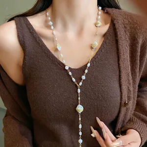 Elegant long irregular pearl necklace sweater chain on model for autumn winter styling