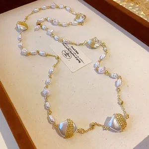 Detail view of an elegant French style long necklace with irregular pearls and gold mesh accents