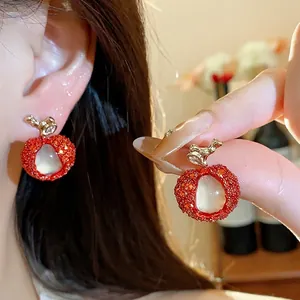 Handmade red litchi fruit shaped earrings with sparkling zircon and translucent resin