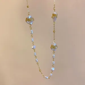 Detail of French luxury irregular pearl necklace with intricate gold wire wrap decoration