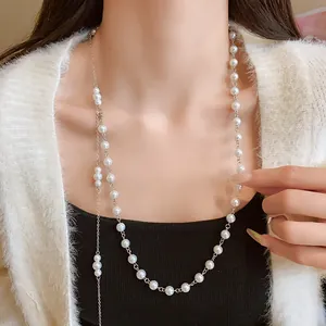 Elegant French style irregular pearl long necklace on a model wearing a cardigan