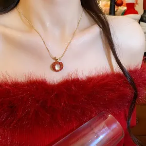 Close-up detail of a stylish red zircon litchi fruit pendant necklace on model's neck