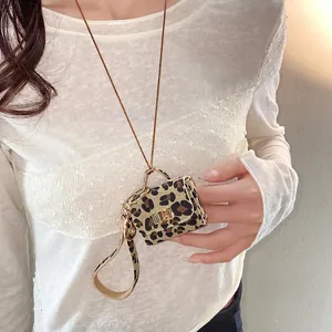 Chic leopard print mini bag pendant necklace featuring a detachable cord and gold latch