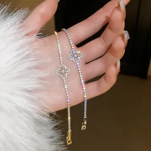 Close-up of elegant four-leaf flower zircon bracelets in gold and silver finish