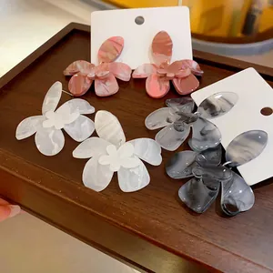 Artistic resin flower earrings with marble pattern in pink, white, and gray colors