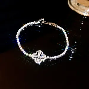 Close-up of sparkling four-petal flower zirconia bracelet with brilliant light refraction