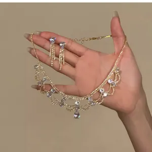 Close-up of vintage royal style gold jewelry set with sparkling water-drop crystals