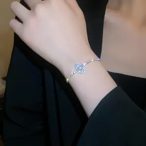 Close-up view of elegant gold-plated four-leaf clover bracelet with sparkling zircon stones