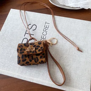 Mini leopard print bag necklace pendant with golden clasp and leather lanyard detail