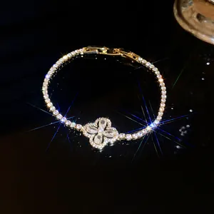 Close-up of a sparkling gold-plated flower bracelet with cubic zirconia details.