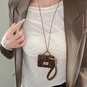 Elegant leopard print mini leather pouch necklace detail worn on white lace top