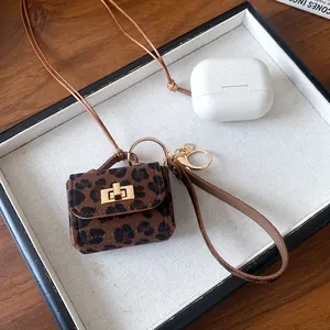 Close-up of leopard print leather jewelry bag with detachable gold clasp strap