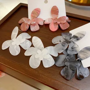 Detail view of forest flower resin earrings in pink, white, and gray gradient finish