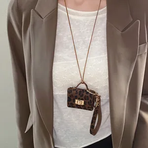 Detailed view of leopard print mini bag pendant necklace on model
