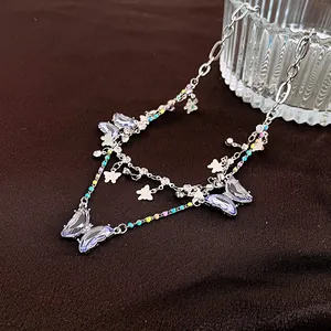 Detail view of silver butterfly necklace with colorful beads and zircon accents.