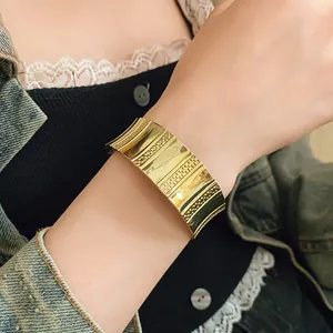 Elegant wide gold textured cuff bracelet with a minimalist luxury open design for women