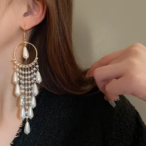 Macro detail of French retro long tassel earrings featuring elegant white pearls and zircons