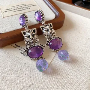 Exquisite vintage-style silver-tone cat drop earrings featuring purple oval stones