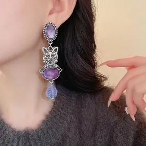 Elegant vintage-style silver-tone cat drop earrings featuring purple stones and intricate detail