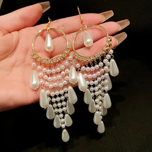 Detail view of French vintage style long tassel earrings with white pearls and zircon