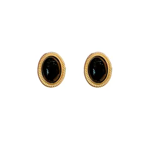 Vintage style oval stud earrings featuring black stone and textured gold-tone frame design