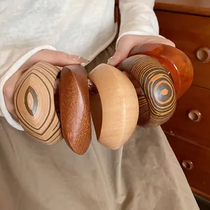 Detail of handcrafted retro wood grain bangles in various textures and warm amber tones