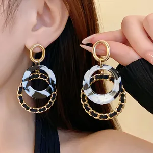 Elegant Korean style gold and marble resin hoop earrings with twisted chain detail