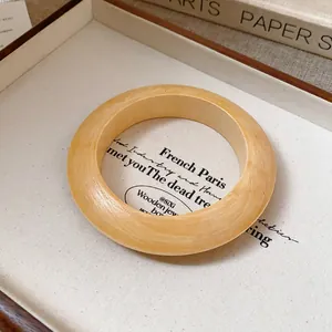Close-up detail of retro wood grain bangle with smooth matte finish