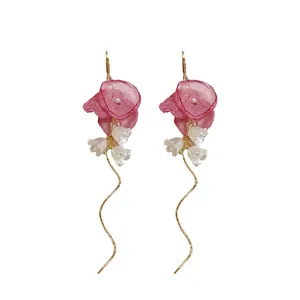 Elegant pink chiffon flower and white bell lily tassel earrings with gold ear hooks.