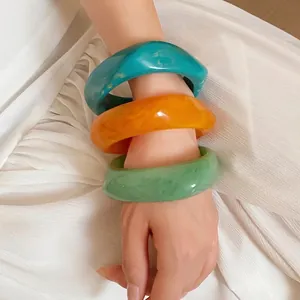 Set of three chunky resin marbled spiral bangles in turquoise amber and mint green