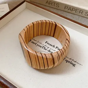 Detailed view of vintage wood grain bangle with elegant vertical striped pattern