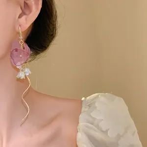 Detailed view of chiffon flower earring with delicate zircon and pearl tassels