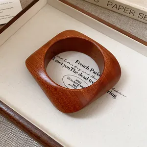 Close-up of vintage wooden bangle showing natural grain and square silhouette