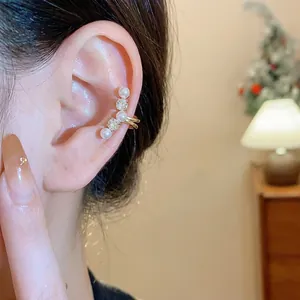 Elegant gold zircon and pearl ear cuff for non-pierced ears, dainty French style jewelry.