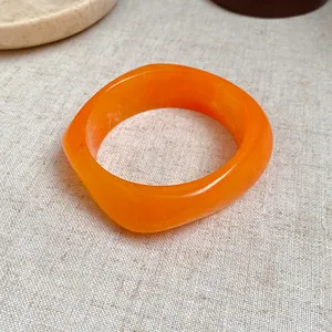 Vintage orange marbled resin square spiral bangle with a unique geometric fashion design