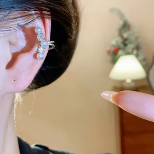 Detail shot of an elegant silver ear cuff featuring pearls and zircons for non-pierced ears