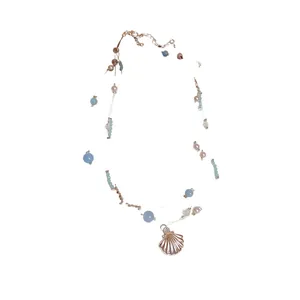 Multi-layered beach resort style necklace with silver shell pendant and blue beads