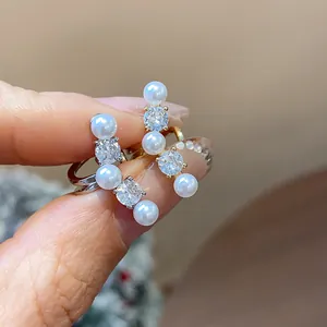Close-up detail of elegant zircon and pearl ear bone clips designed for non-pierced ears